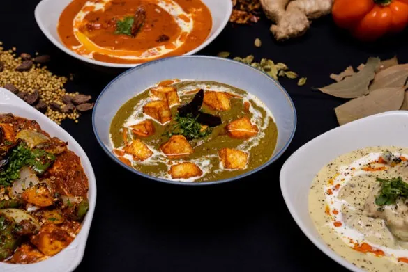 Chacha Wow signature dishes - Butter Chicken, Goat Curry, and Thali Platters in Winnipeg